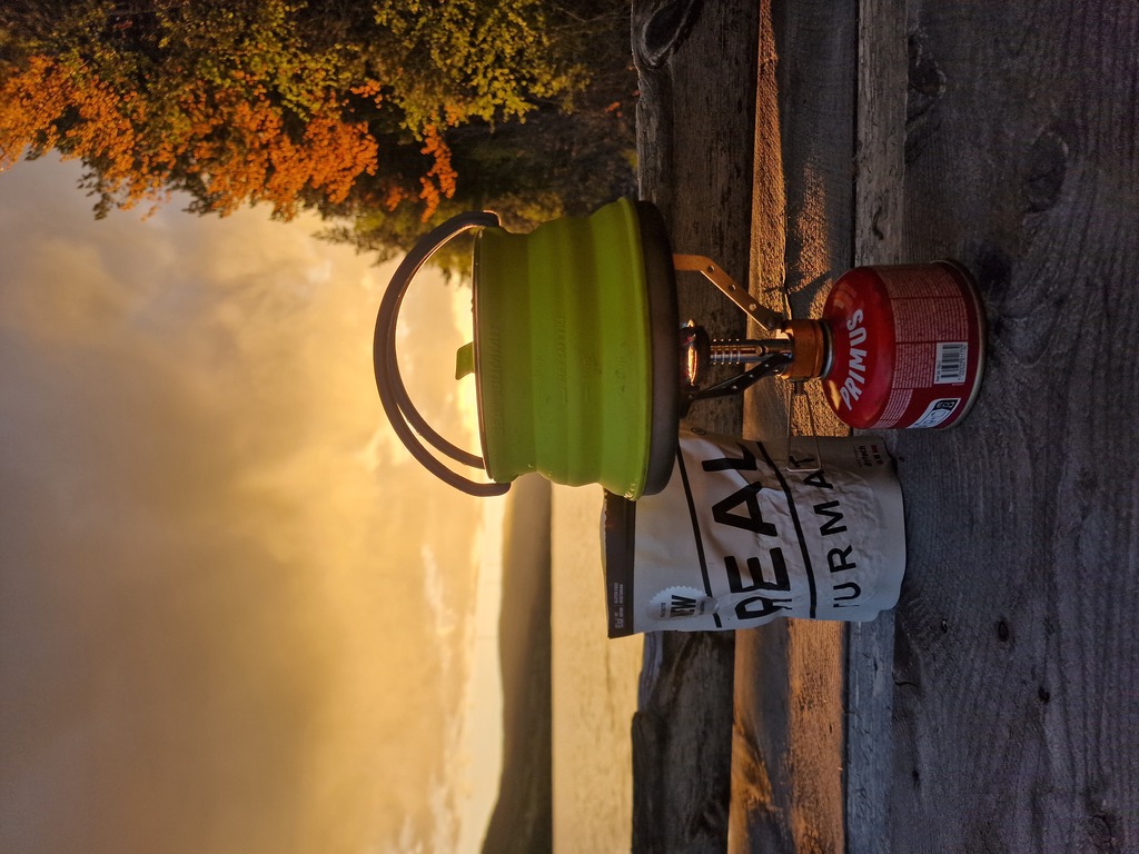 My cooking equipment with the sun setting behind it.